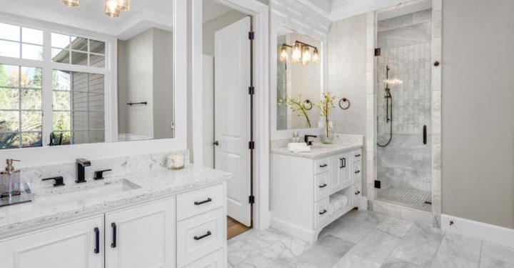 Beautiful bathroom in new luxury home with two vanities, sinks, and mirrors.