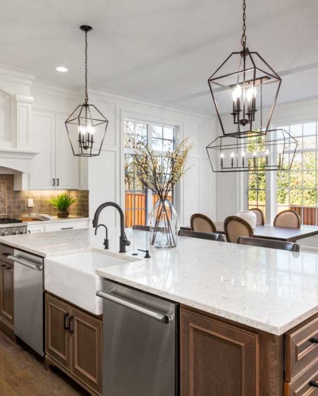 Beautiful kitchen in new traditional style luxury home, with quartz counters, hardwood floors, and stainless steel appliances